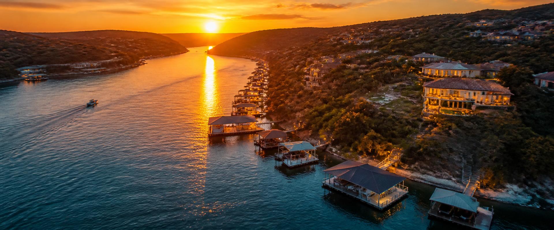 Aerial view of Lake Travis docks at golden hour with Austin hill country